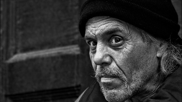 An old, slightly sad looking man, photographed in black and white