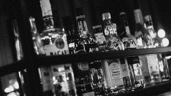 A row of bottles that you might see inside a bar or public house.